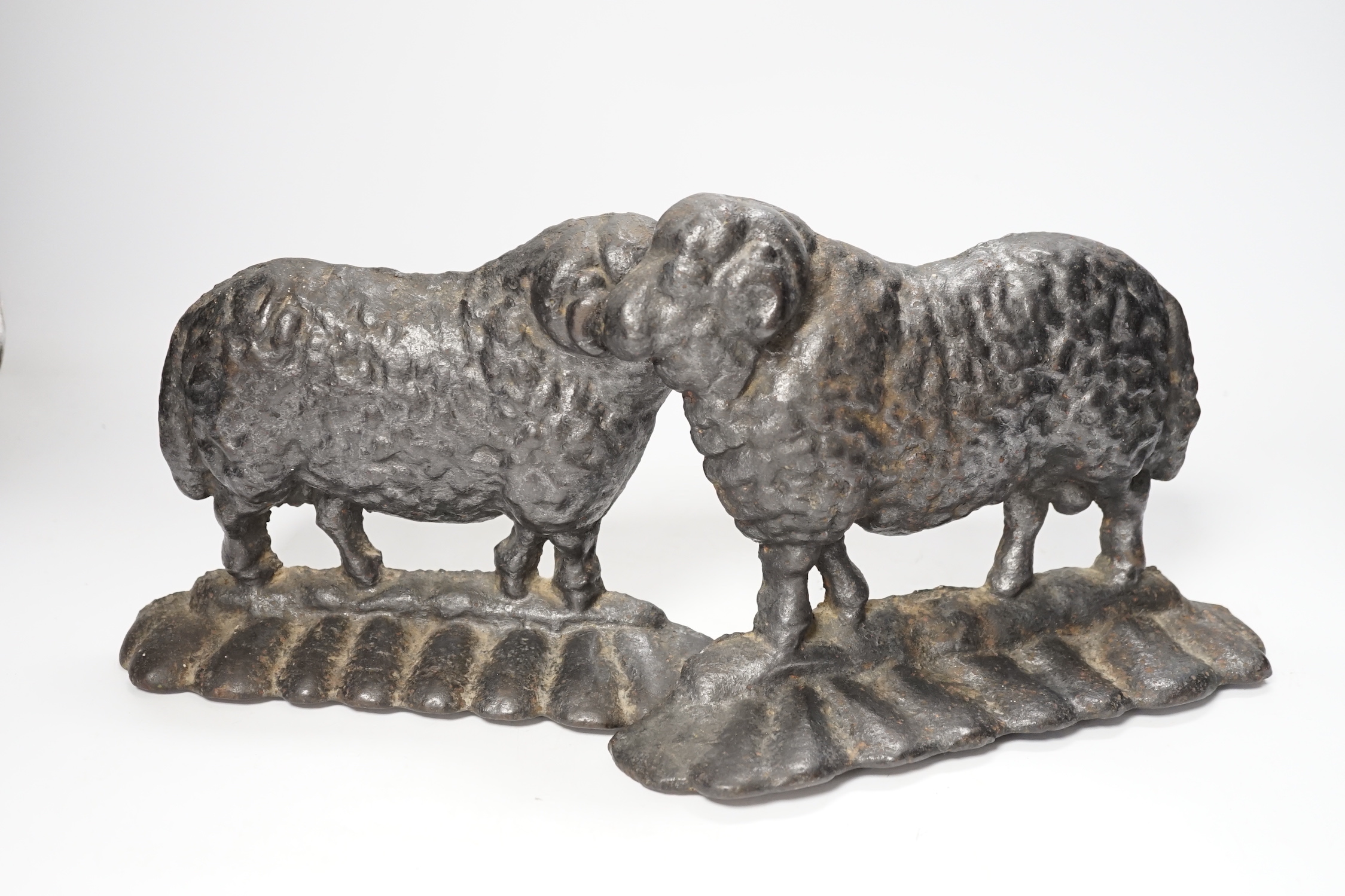 Two 19th century cast iron door stop sheep, tallest 19cm high